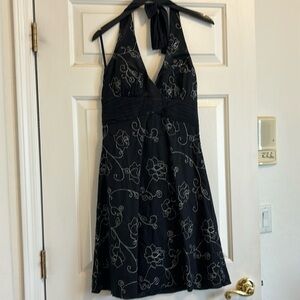 White House black market dress. Sleeveless and back less with tie around neck.